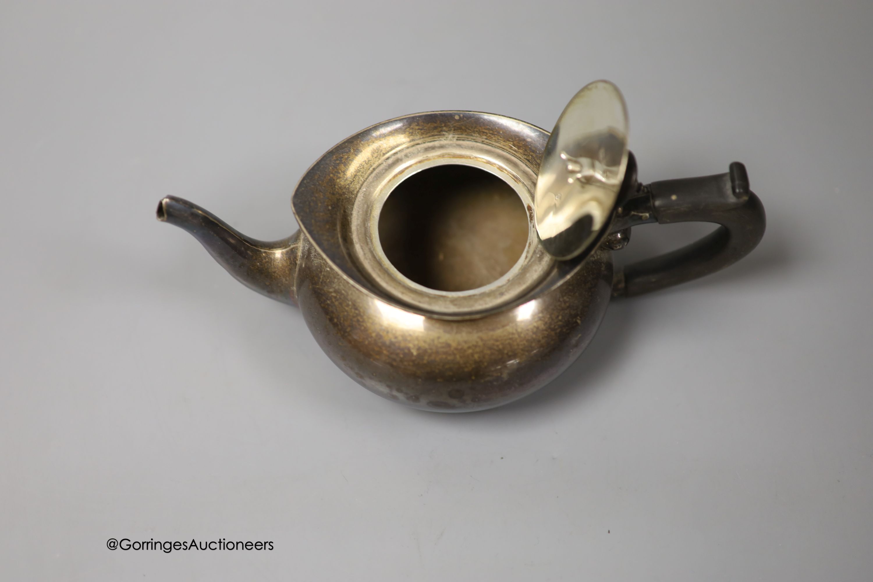 An Edwardian silver bachelor's squat circular teapot, T. Wooley, Birmingham, 1909, gross 9.5oz.